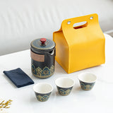 Travel-friendly teaware with teapot, cups, and soft yellow pouch