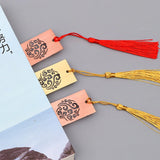 Three bookmarks with tassels on a gray background