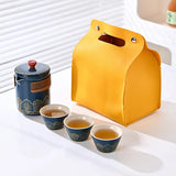 Yellow carrying case next to a blue tea set with cups on a white inner surface.