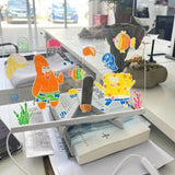 Colorful cartoon characters on a transparent stand in an office setting