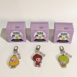 Three Calm's Charm keychains with their packaging on a white background