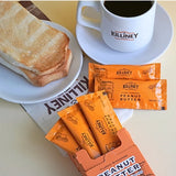 A box of peanut butter is placed next to the bread and coffee for breakfast.