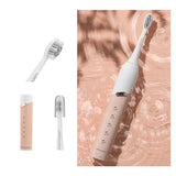 Electric toothbrush with interchangeable heads on a textured background