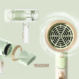 Green hair dryer with different attachments on a light green background
