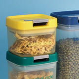 LocknLock food storage containers with yellow, green, and blue lids on a blue background.