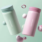 Two Lock&Lock thermos bottles, one green and one pink, on a light green background.