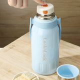 Light blue thermos bottle with 'LocknLock' branding on a wooden surface.