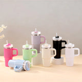 Set of colorful insulated mugs with lids on a neutral background