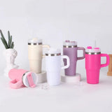 Set of colorful insulated mugs with handles on a light background