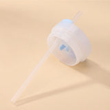 White cup with a straw on a beige background