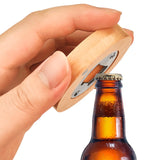 Hand using a wooden bottle opener on a beer bottle against a white background