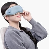 Person wearing a blue eye mask on a white background