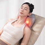 Woman using a neck and shoulder massager on a white background
