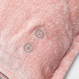 Close-up of a textured pink fabric with two circular patterns.