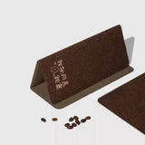 Brown textured card with embossed text on a light gray background