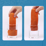 Orange mesh filter being placed into a glass on a blue background