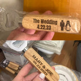 Two wooden wedding cake knives with engraved dates and names.