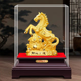 Gold horse statue on a red base with a glass display case, against a dark background.