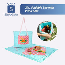 Turquoise and pink quilted 2-in-1 picnic mat bag unfolded on grass with picnic snacks_ corporate gift_customised gift singapore