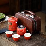 Red tea set with a brown suitcase 