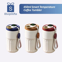 Cream and silver 450mlSmartTemperatureCoffeeTumbler with LED lids and leather straps on a wooden surface. Gift SHop