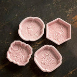 Four different shaped snack dishes