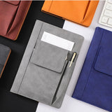 Grey Suede A5 Executive Notebook with external pocket and pen holder on a minimalist desk_corporate door gift