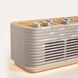 Minimalist ambient speaker glowing with warm light in a modern room
