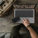 Belkin 65W Multi-Port Laptop Power Bank in matte black finish charging a laptop and smartphone_ Customised Corporate Gift.
