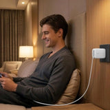 White Belkin 45W Dual USB-C GaN Wall Charger with retractable pins on a minimalist desk. _ Customised Corporate Gift