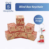 Stack of blind box keychains with a custom design keychain featuring a lion and Singapore flag.