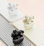 Three pairs of earbuds in black, white, and light yellow on a striped background