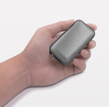 Hand holding a speaker