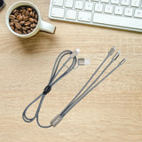 Multi-device cable on a desk with a cup of coffee and keyboard