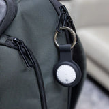 Black BrandCharger Bluetooth tracker in leather case with silver multi-tool on a dark wood surface_ customised Corporate Gifts