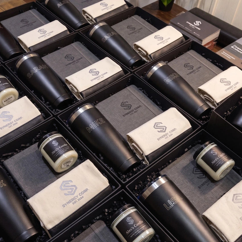 Collection of branded items including tumblers and towels arranged in a grid.