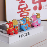 Colorful ceramic figurines on a Vogue magazine with Chinese characters in the background