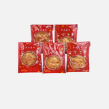 Four gold coins in red packaging on a white background