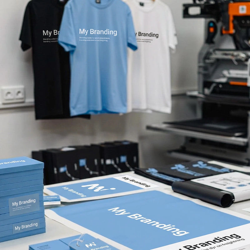 T-shirts with 'My Branding' text in a printing facility.