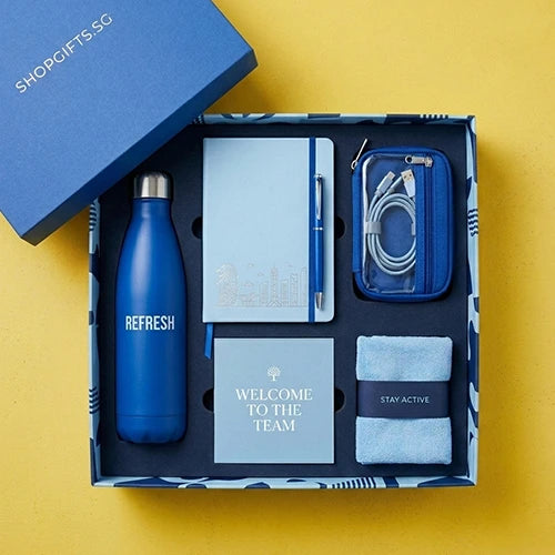 Gift set with blue water bottle, notebook, card, and pouch on a yellow background