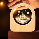 Celestial 3D Engraved Crystal Mood Lamp with space scene in a wooden frame on a desk_ corporate gift supplier