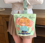 Person holding a tote bag with a cartoon character and 'Tulip in June' text.