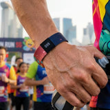 Vibrant Premium Custom Sublimated Elastic Wristband with numbered tag on a runner's wrist_ corporate gift