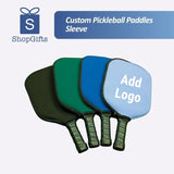 Four colorful Pro-Shield Neoprene Pickleball Paddle Covers in black, green, and blue on a green grass background_Customised Corporate Gifts