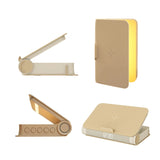 Wireless charging book lamp glowing softly with phone placed on top