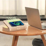 Wireless charging book lamp glowing softly with phone placed on top