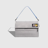 Gray shoulder bag with a blue strap on a light gray background