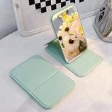 Ultra-thin 10.7*7* 1cm foldable makeup mirror shown in both a stand-up desktop vanity position and a closed, compact state for easy carrying