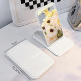 Ultra-thin 10.7*7* 1cm foldable makeup mirror shown in both a stand-up desktop vanity position and a closed, compact state for easy carrying