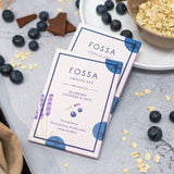 FOSSA Chocolate bars with blueberries and oats on a gray surface
